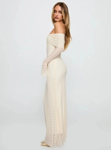 Detail of off-white lace off-shoulder dress with bell sleeves and slim fit silhouette