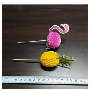 Close-up of flamingo and pineapple paper picks showing 12-13 cm length with ruler