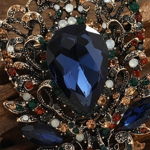 Detailed macro shot of vintage drop-shaped blue crystal brooch with colorful rhinestones