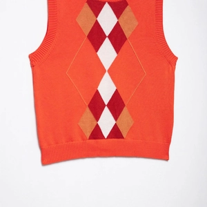 Classic argyle knit vest in vibrant orange with white and brown diamond patterns