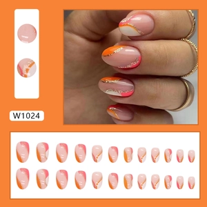 Short oval press-on nails featuring pink and orange swirl patterns with gold glitter lines