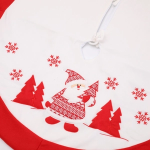 Detail of premium red and white Christmas tree skirt with embroidered Santa and snowflake