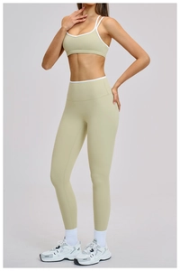 Details von High-Waist-Yogahose und Sport-Top mit weißem Saum und schmalen Schultergurten