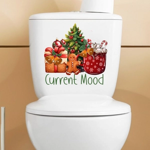 Christmas tree and gingerbread man decals applied to a white toilet tank for holiday decor