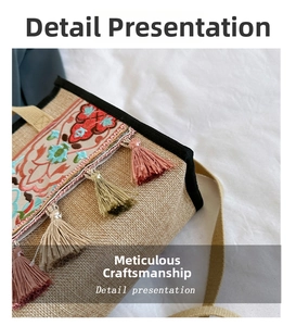Close-up of ethnic embroidery and colorful tassel on linen tote bag details
