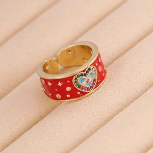 Close-up of red enamel heart evil eye ring with gold star embossing and colorful crystals