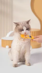 Macro detail of ergonomic cat strip feeder spoon showing healthy feeding usage with a cat