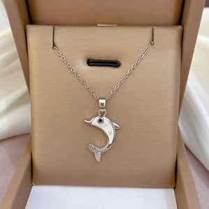 Titanium steel dolphin necklace with shell inlay and cubic zirconia in a jewelry box