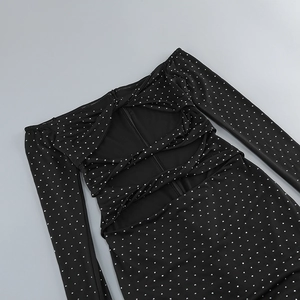 Close-up of black dress with sparkling rhinestones and elegant back cutout detail
