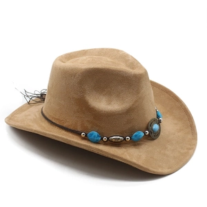 Close-up of suede cowboy hat with turquoise beads and tassel trim on brown band