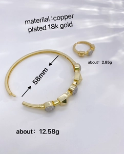 Macro detail of 18K gold plated copper jewelry set with dimensions and weight info