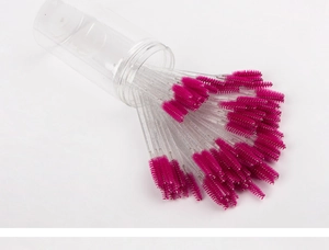 Macro view of rose red spiral eyelash brushes with glitter handles in a clear storage tube