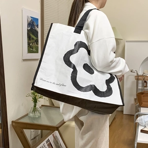 Floral knit tote bag with black flower pattern and large capacity for beach or travel