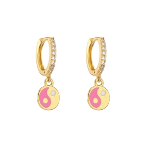 Macro detail of gold-plated hoop earrings with pink and white yin yang pendants and cubic zirconia