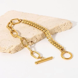 Detail of gold titanium steel bracelet with asymmetric link chain and elegant OT toggle clasp