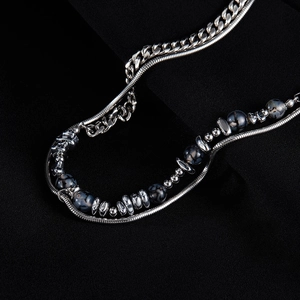 Close-up of double-layer stainless steel Cuban and snake chain with black hematite beads