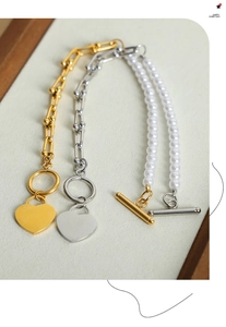 Detail of the heart pendant bracelets with U-link chain and pearl accent toggle clasp