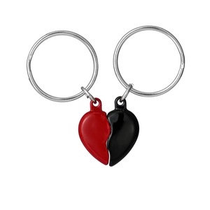 Macro shot of magnetic red and black heart pendants on silver metal keychains