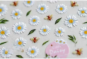 Macro shot of 5D daisy embossed nail stickers with textured bees and floral details