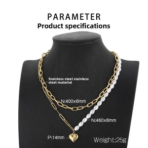 Detail view of double-layer stainless steel necklace with heart pendant and freshwater pearls