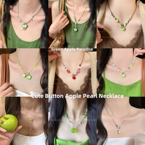 Detailed grid of green apple beaded necklaces with resin charms worn by a model