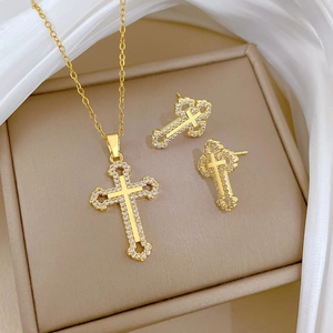 Titanium steel hollow cross necklace and earrings set with crystal inlay on a gift box