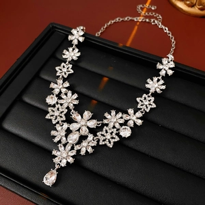 Detail of silver vintage flower necklace with sparkling crystals and droplet pendant