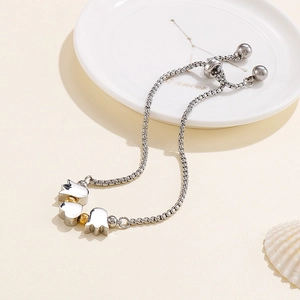 Adjustable silver tulip bracelet with gold beads on decorative marble tray background