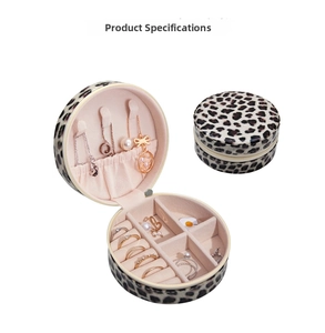 Detail view of round leopard print jewelry box showing necklace hooks and ring slots