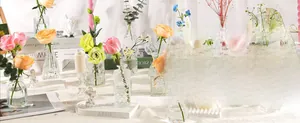 Elegant clear glass bud vases set with candles and floral decor for wedding home tables