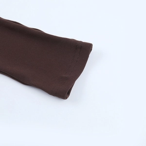 Close-up of double-stitched cuff on a brown knit jumpsuit featuring high-quality fabric texture