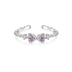 Detail of S925 silver ring featuring butterfly bow and purple heart-shaped gemstones