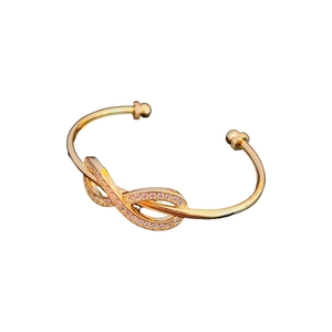 Elegant gold plated infinity symbol open bangle with sparkling cubic zirconia stones