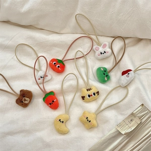 Detail shot of cute cartoon plush hair ties with various animal and fruit shapes