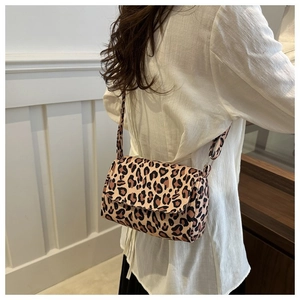 Leopard print crossbody bag side view on model showing flap closure and shape