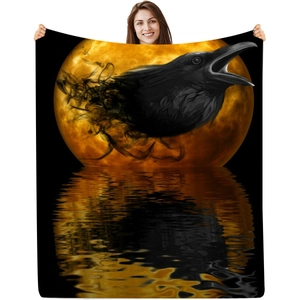 Detail of gothic raven and orange full moon digital print on soft flannel blanket