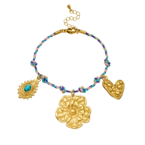 Macro detail of braided cord bracelet with turquoise teardrop and golden flower charms