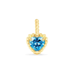 Macro detail of heart-shaped sky blue zircon pendant with gold bead texture edging