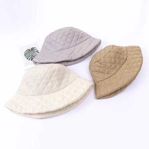 Detailed top view of quilted diamond fisherman hats in gray, cream, and khaki colors