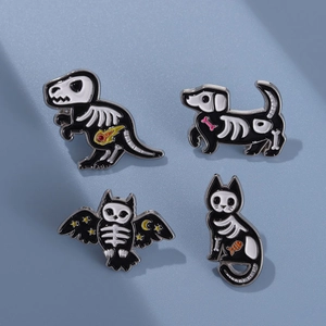 Four punk-style animal skeleton enamel pins featuring cat, dog, owl and dinosaur designs
