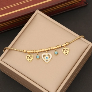 Golden stainless steel snake chain necklace with heart charms and evil eye detail