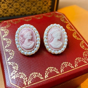 Vintage style pink cameo earrings with white pearls and gold-tone metal finish