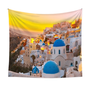 Detail of Santorini sunset wall tapestry featuring blue-domed churches on white walls