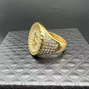 Macro shot of hip-hop gold signet ring with micro-pave crystals and letter B logo
