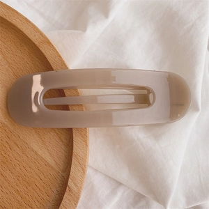 Detail view of large matte jelly texture hair clip with hollow geometric center
