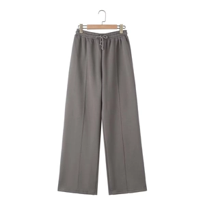 Detail of grey wide-leg sweatpants with drawstring waist and stitched center seam