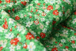 Detailed macro view of the floral print cotton fabric with precise stitching and textures