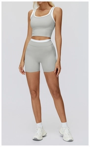 Detail of high-waist yoga shorts and racerback sports bra with white contrast trim