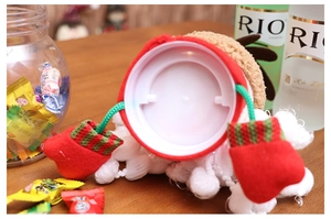 Close-up of Christmas reindeer plush jar lid decoration with festive knitted gloves