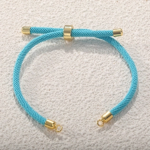 Detail of blue Milanese woven cord bracelet with adjustable gold-plated slider and end caps